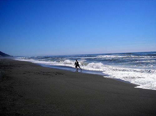 Boys on the beach with waves CA